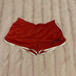 Red running shorts with Louisville Cards logo